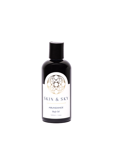 Botella de 120ml del aceite corporal Abundance de Skin & Sky con etiqueta blanca, detalles en dorado.
