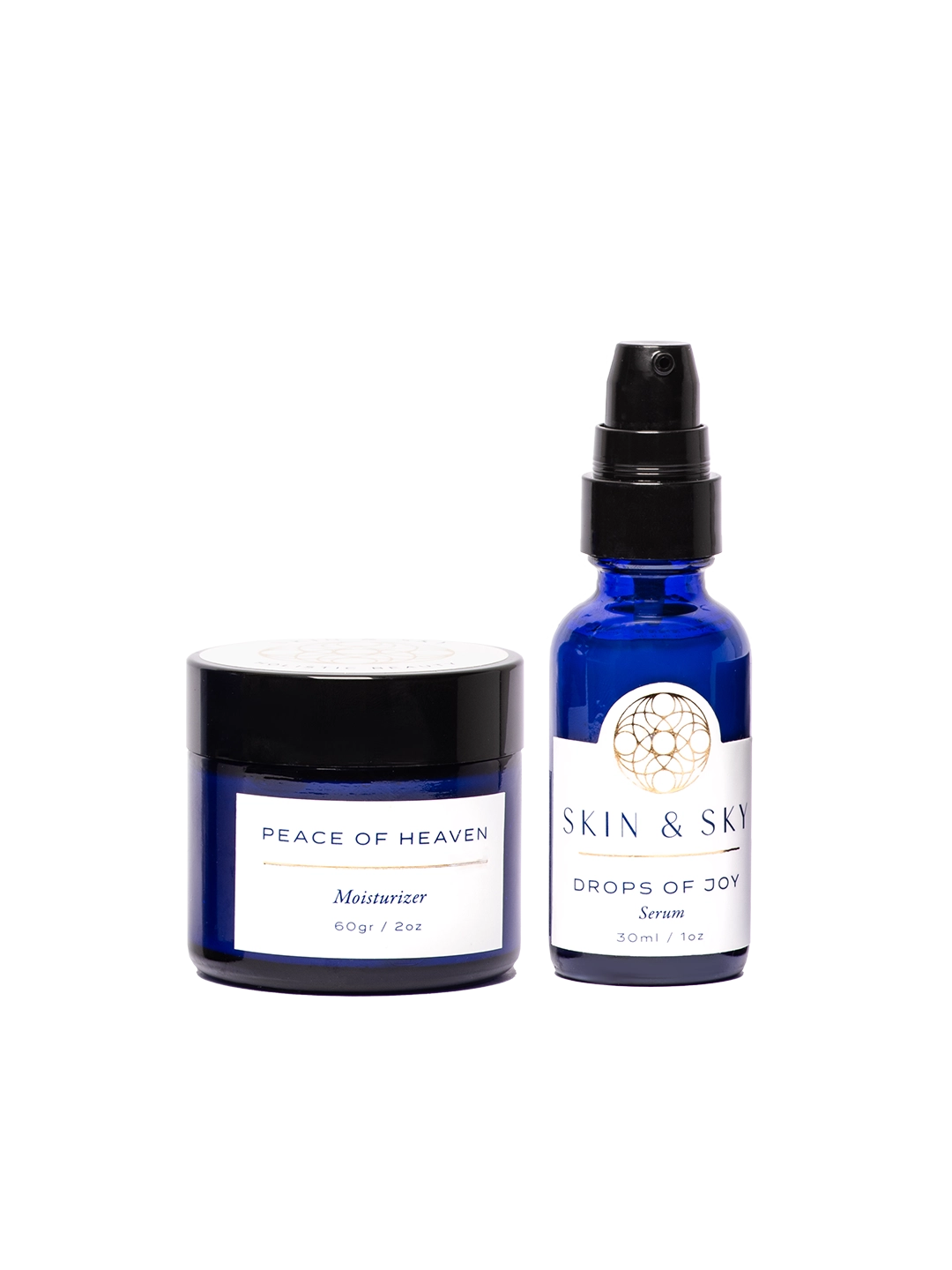Blissful Set de Skin & Sky que incluye la crema hidratante Peace of Heaven (60g) y el serum Drops of Joy (30ml) en elegantes envases de vidrio azul cobalto con etiquetas blancas, diseñado para restaurar el equilibrio y la luminosidad natural de la piel.