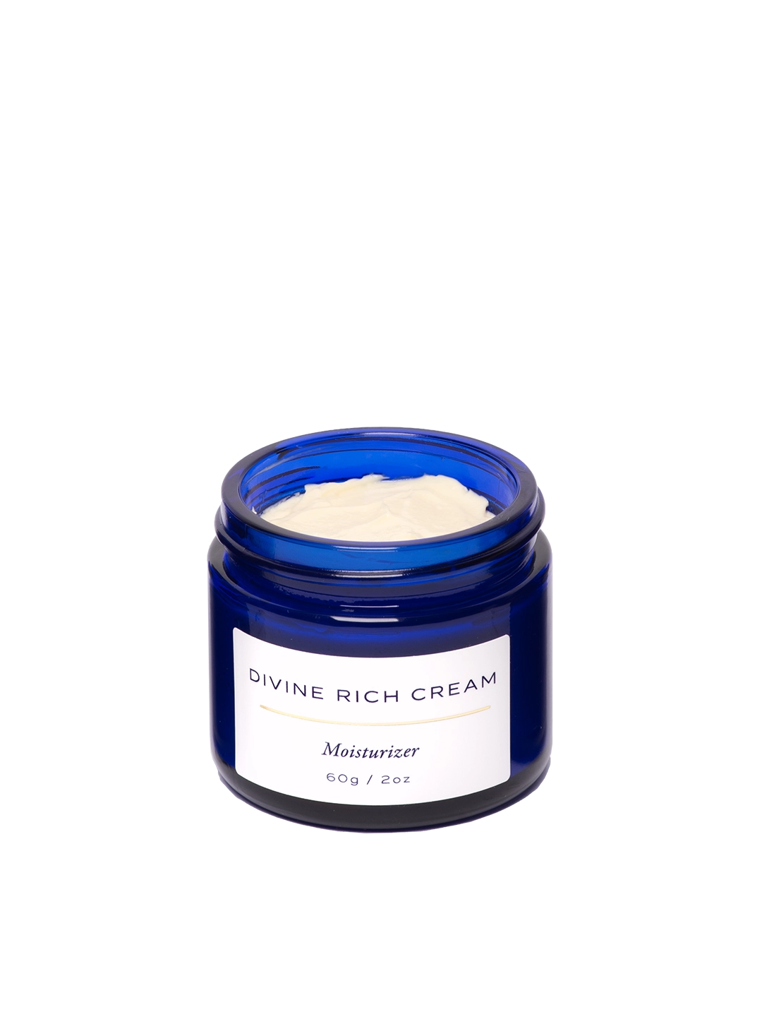 Primer plano del tarro abierto de Divine Rich Cream de Skin & Sky; muestra una textura rica, densa y cremosa de color marfil, diseñada para nutrir profundamente y reparar la barrera cutánea.